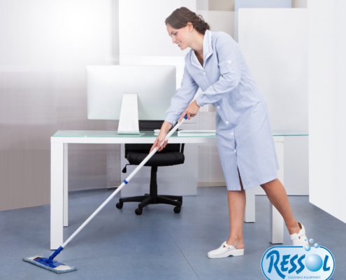 portrait of happy female janitor cleaning floor at office